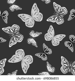 Seamless background from butterflies. Beautiful butterflies chaotically fly randomly. Vector. Suitable for fabric, paper, packaging.