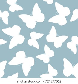 Seamless background from butterflies. Beautiful butterflies chaotically fly randomly. Vector. Suitable for fabric, paper, packaging.