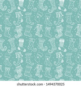 Seamless background with christmas gift socks on green mint background. Can be used for wallpaper, pattern fills, textile, web page background, surface textures