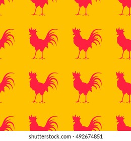 Seamless background with colorful poultry. Red rooster on a yellow background.