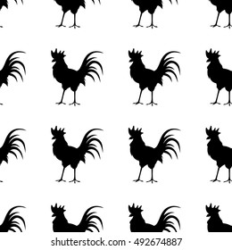 Seamless background with colorful poultry. Red rooster on a yellow background.