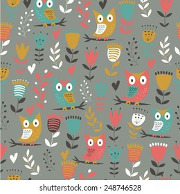 Seamless background with cute owls, flowers and hearts in cartoon style