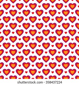 Seamless background with different sized colorful hearts in red, yellow and purple colors on white backdrop 