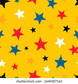 Seamless background of doodle stars. Multicolor hand drawn stars on yellow background. Vector illustration