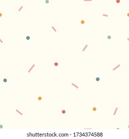 Seamless background of dots and dashes. Soft, cozy colors. Vector seamless pattern, can be used for fabrics, wallpaper, web, wrapping paper, card and more.
