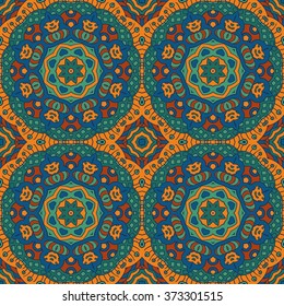 Seamless background. Ethnic doodle motives. Zentagl. Orange, green and blue