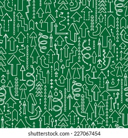 Seamless background of hand drawn arrows on green background.