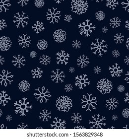 Seamless background of hand drawn snowflakes. Blue snowflakes on dark blue background. Christmas and New Year decoration elements. Vector illustration.