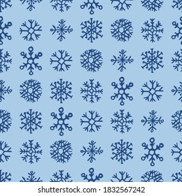Seamless background of hand drawn snowflakes. Christmas and New Year decoration elements. Vector illustration.
