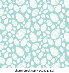 Seamless background for happy Easter day. The decorative  white color Easter eggs with different patterns and different sizes on a blue background.