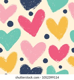 Seamless background with hearts in bright tones. Expressive dry brushes.