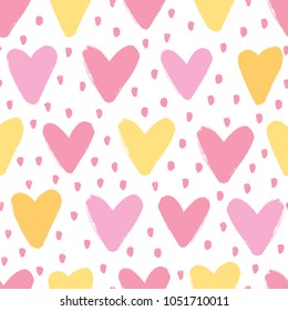 Seamless background with hearts in pink and yellow tones. 