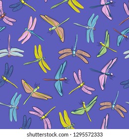 Seamless background of images of colored dragonflies on blue background