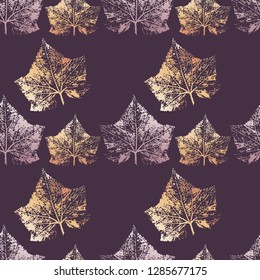 Seamless background from the leaves of a cucumber in a gradient color on a purple background.