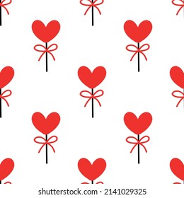 Seamless background with lollipops on a stick in the shape of a heart. pattern on valentines day. Vector illustration