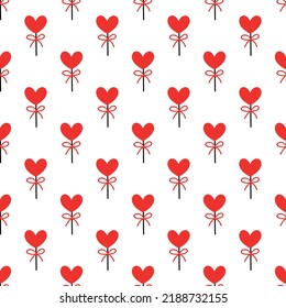 Seamless background with lollipops on a stick in the shape of a heart. pattern on valentines day. Vector illustration