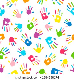Seamless background made from colorful handprints. Palms and fingers colored in rainbow colors.  Multicolor pattern for your design.