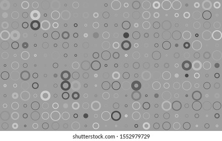 Seamless background pattern from circles of various sizes and different shades on a grey background