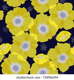 Seamless background pattern of delicate Yellow floral blossom or soft flowering symbolic of Spring in a random arrangement on a dark blue background. hand drawing style.