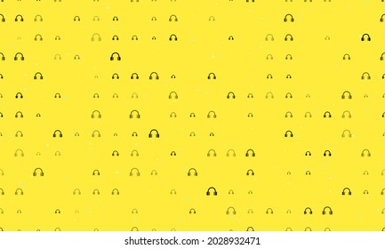 Seamless background pattern of evenly spaced black headphones symbols of different sizes and opacity. Vector illustration on yellow background with stars