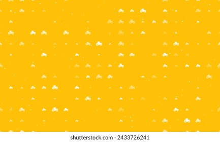 Seamless background pattern of evenly spaced white tractor icons of different sizes and opacity. Vector illustration on amber background with stars