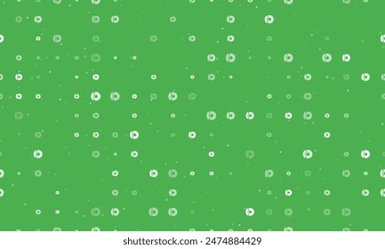 Seamless background pattern of evenly spaced white auto brakess of different sizes and opacity. Vector illustration on green background with stars