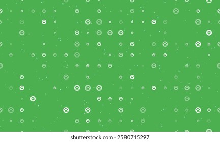 Seamless background pattern of evenly spaced white pet symbols of different sizes and opacity. Vector illustration on green background with stars