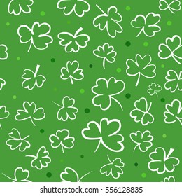 A seamless background pattern with hand drawn ink shamrocks on green