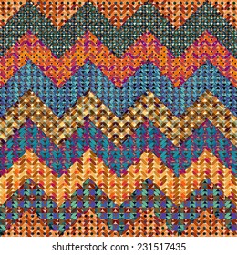 Seamless background pattern. Knitted chevron on patchwork background