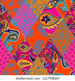 Seamless background pattern. Patchwork pattern with Paisley ornament patterns. Bright magenta and orange colors. Ethnic indian style.