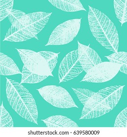 A seamless background pattern of vector skeleton leaves in teal blue, autumnal repeat print