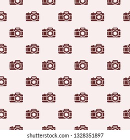 Seamless background with photo cameras. Vector illustration. Abstract photo cameras pattern.