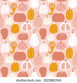 Seamless background with pumpkins in the autumn color palette. Flat cartoon style.