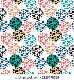 Seamless background of small and large circles. Different colored polka dots. Modern palette for textiles and packaging.