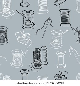 Seamless background of spools of threads and needles