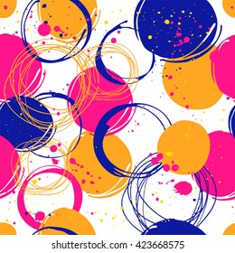 Seamless background with spots and splashes of paint. Vector illustration of the graphic elements of the round form. Colorful pattern: orange, blue and yellow.