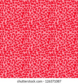 Seamless background of tiny, hand drawn red hearts, on a pink background