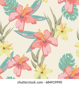 Seamless background with tropical flowers and palm leaves. Suitable for clothing and textiles