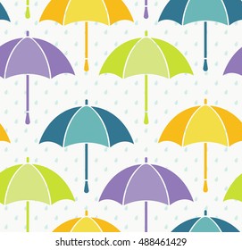 Seamless background, various colorful umbrellas and blue rain drops on white. Vector.