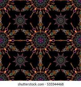 Seamless background. Violet, blue and pink ornament on a black background. Floral seamless pattern. Wallpaper baroque, damask.