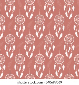 Seamless background of white feathers and dream catchers on a colored background. Pattern.