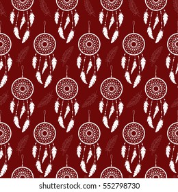 Seamless background of white feathers and dream catchers on a colored background. Pattern.