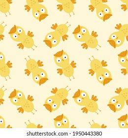Seamless background with yellow owls for printing on baby fabric. Wallpaper with an owl for sewing children's clothing and packaging paper.