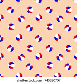 Seamless beach ball repeating background pattern. Beach balls in patriotic America colors of red white and blue over a light brown background.  Flat color style. Useful for Fourth of July projects