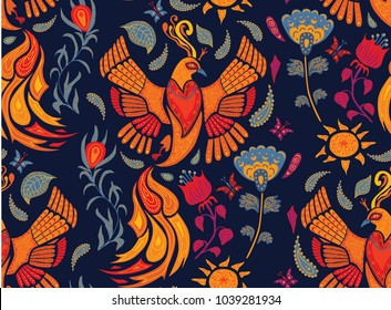 Seamless beautiful vector with fantasy orange drawing firebird and blue flowers on a dark blue background.