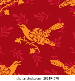 Seamless bird pattern (vector). Red and yellow pattern with birds and branches.