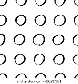 The seamless black and white abstract brush stoke pattern. The creative monochrome hand drawn background with circles for your design.