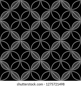 Seamless black and white pattern of dotted intersected white flowers and leaves. Floral trellis. Mosaic floral lattice. Monochrome print of beads. Vector Illustration.