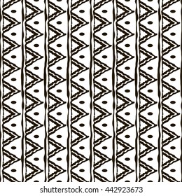 Seamless black and white pattern with ethnic motifs. Vertical stripes, triangular shapes and small ovals. Abstract geometric ornament in hand drawing style. Vector illustration for creative design