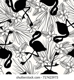 Seamless black and white pattern with flamingo silhouettes, tropical leaves and flowers. Ideal for wallpaper, fabric, wrapping paper and summer stationery.